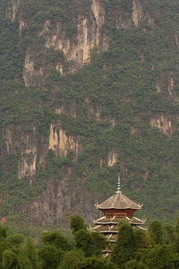 Pagoda and Giant Karst Peak Behind Yangshuo Bridge Poster Print by Adam Jones.