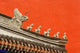 Rooftop figures and colorful wall art print of Forbidden City, Beijing, China.
