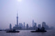 Poster print of water traffic on Huangpu River with Oriental TV Tower and Pudong skyline in Shanghai, China.
