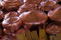 Copper kettles displayed at Lijiang Market in Yunnan Province, China.