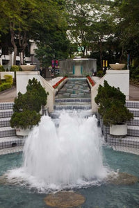 Waterfall in Hong Kong Park poster print by Julie Eggers showcasing serene nature.