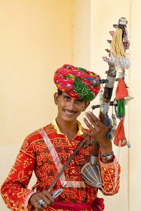 Young man playing sarangi traditional instrument in Agra, India poster print.