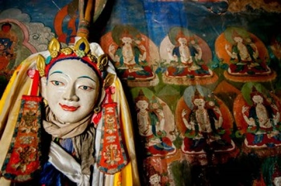 Religious statue in front of Buddha mural at Shey Palace poster print