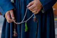 Woman's hands holding prayer beads in Ladakh, India poster print
