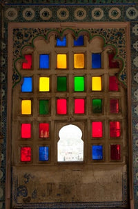 Brightly colored glass window at City Palace, Udaipur, Rajasthan, India - Poster Print by Inger Hogstrom