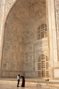 Visitors dwarfed by the majestic Taj Mahal poster print by Inger Hogstrom
