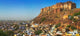 Cityscape of the Blue City with Meherangarh Fort Poster Print by Keren Su, vibrant blue architecture.