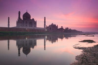 Taj Mahal poster print at dusk along the Yamuna River by Walter Bibikow.