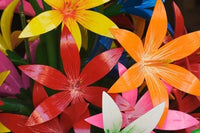 Star shaped carved wooden flowers at market in Bo Sang, Chiang Mai, Thailand Poster Print
