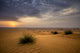 Sunrise in the Desert Art Print by Tom Norring showcasing Abu Dhabi landscape.