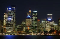 Sydney CBD at Night Poster Print by David Wall showcasing the vibrant skyline of Sydney, Australia.