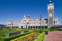 Poster print of Park Near Ornate Railroad Station in Dunedin, South Island, New Zealand.