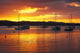 Sunset Over Bay of Islands Poster Print by David Wall depicting a beautiful sunset in Northland, New Zealand.