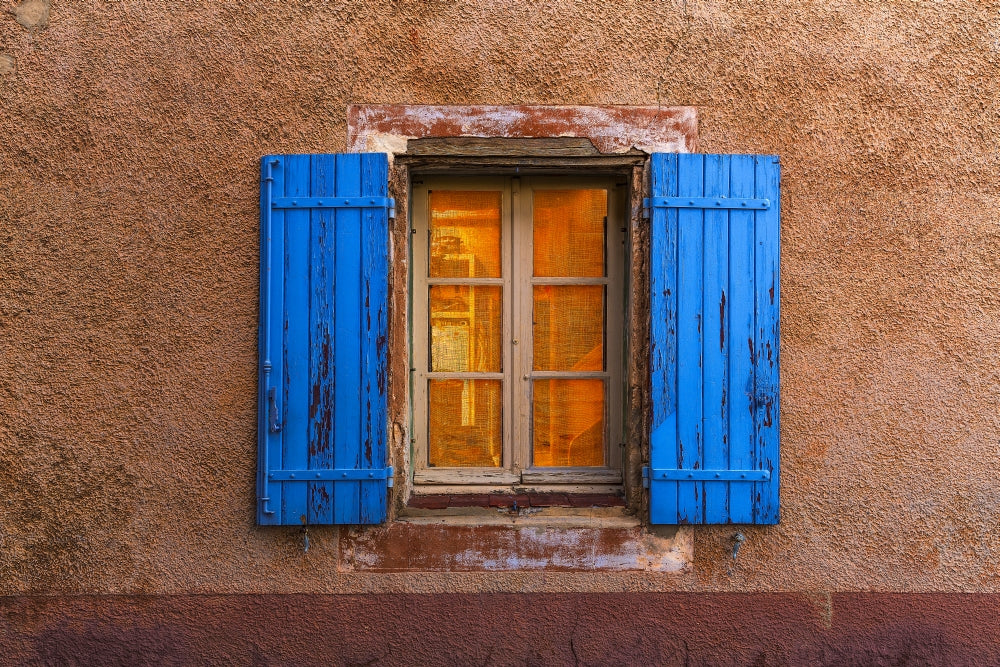 Provence Blue Window Shutters Poster Print showcasing vibrant blue shutters and wall.