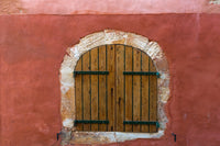 Provence Roussillon Red Shutters Poster Print showcasing vibrant wooden shutters against a red wall.