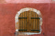 Provence Roussillon Red Shutters Poster Print showcasing vibrant wooden shutters against a red wall.