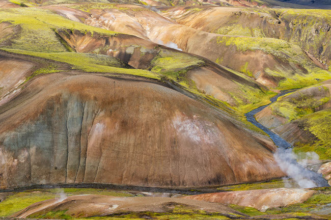 Iceland Fjallabak Nature Reserve Poster Print featuring multicolored lava hills and a small river by Ellen Goff.