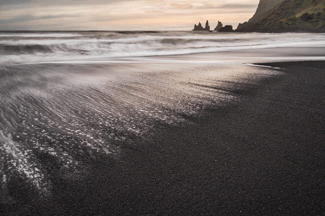 Iceland Reynisfjara Beach Poster Print showcasing stunning black sand beach and sea stacks.