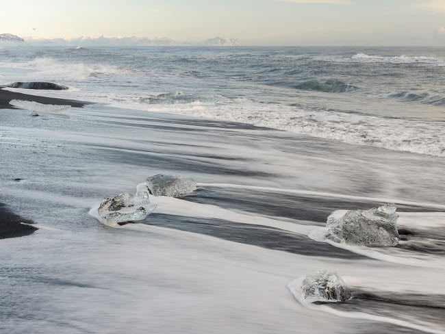 Icebergs on black volcanic beach in Iceland art print by Martin Zwick