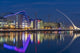 Samuel Beckett Bridge at dusk over the River Liffey in Dublin Poster Print by Chuck Haney