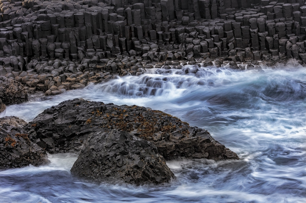 Waves crashing against basalt columns at the Giant's Causeway poster print by Chuck Haney.