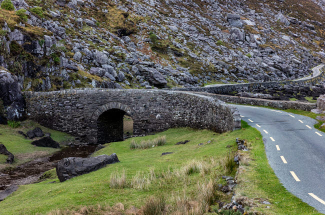 Narrow roadway over stone bridge at the Gap of Dunloe in Killarney, Ireland - Poster Print by Chuck Haney
