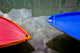 Colorful boat bows and reflections in Burano, Italy poster print.