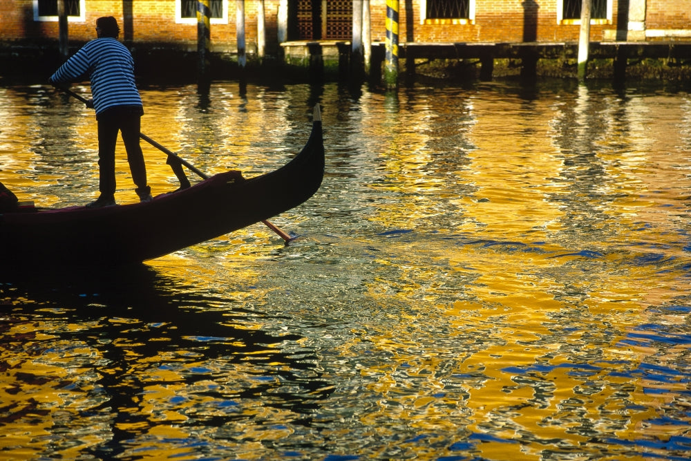 Venice Gondolier steering gondola at sunset poster print.