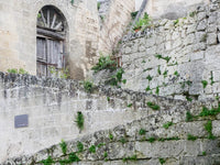 Cobblestone steps leading to a traditional Sassi home in Matera.