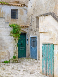 Matera doors in a courtyard poster print by Julie Eggers