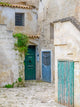 Matera doors in a courtyard poster print by Julie Eggers