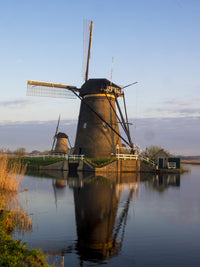 Kinderdijk Windmill along the canal in morning light, poster print by Terry Eggers.