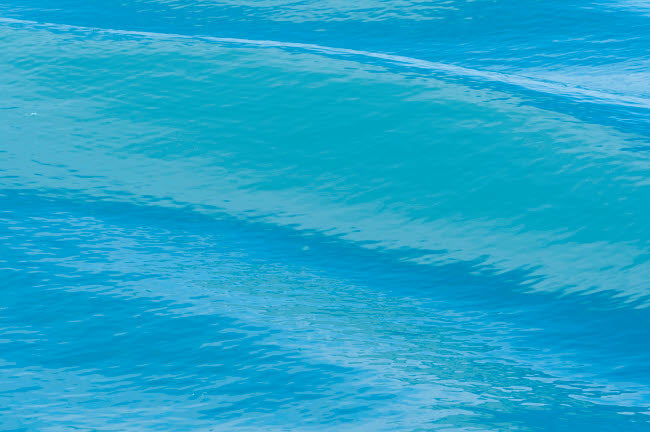Vibrant blue waters surrounding melting glacier in Svalbard poster print by Ellen Goff