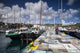 Horta Marina poster print featuring yacht crew paintings on piers by Walter Bibikow.