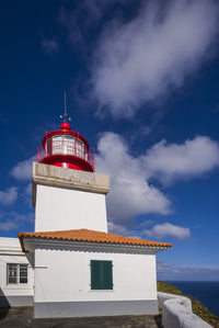 Ponta do Castelo Lighthouse Poster Print by Walter Bibikow, showcasing stunning coastal scenery.
