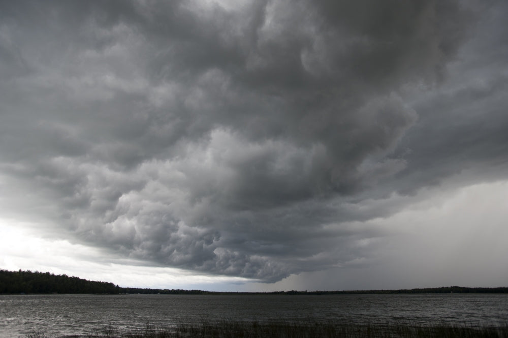 Storm Over Lake Waukaunabo poster print by Gayle Harper showcasing a dramatic landscape.