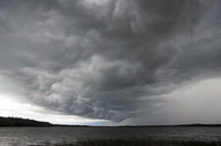 Storm Over Lake Waukaunabo poster print by Gayle Harper showcasing a dramatic landscape.