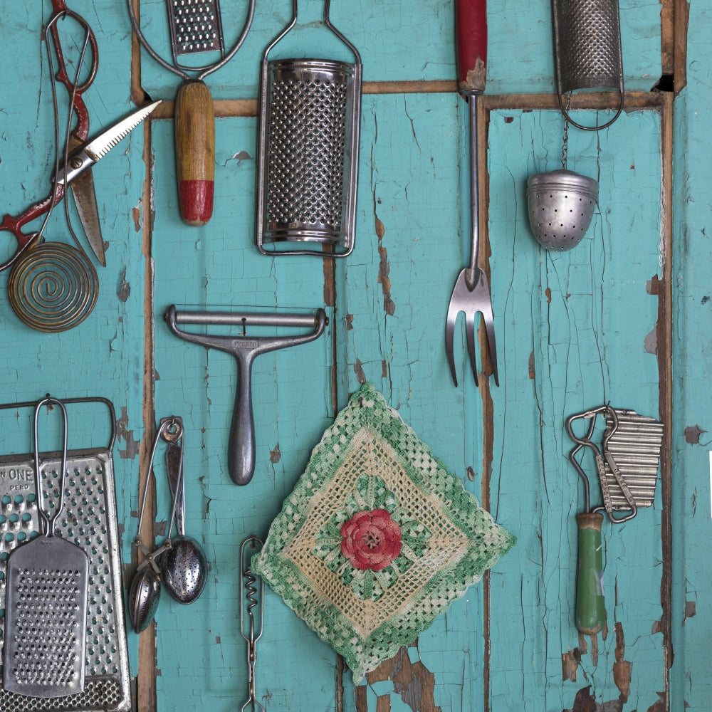 Old fashioned kitchen implements displayed on a weathered door.