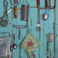 Old fashioned kitchen implements displayed on a weathered door.