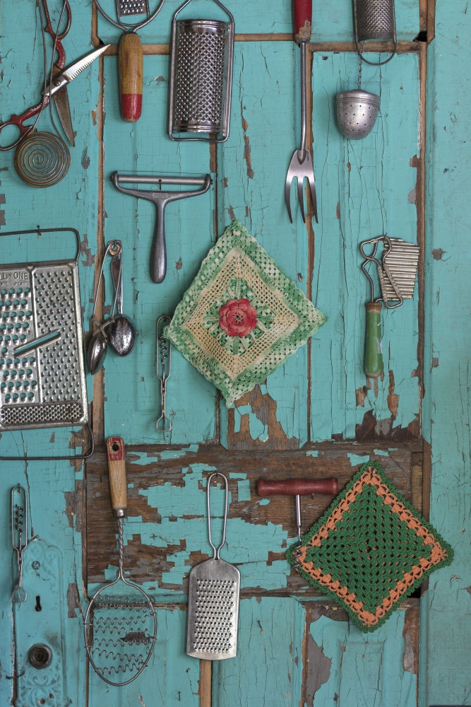 Old-fashioned kitchen implements displayed on a weathered door poster print.