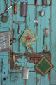 Old-fashioned kitchen implements displayed on a weathered door poster print.