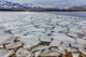 Ice flows at spring breakup on Lake McDonald in Glacier National Park, Montana - Poster Print by Chuck Haney.