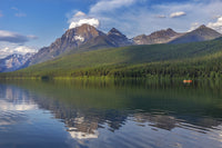 Fishing from a red canoe on Bowman Lake in Glacier National Park Poster Print by Chuck Haney.