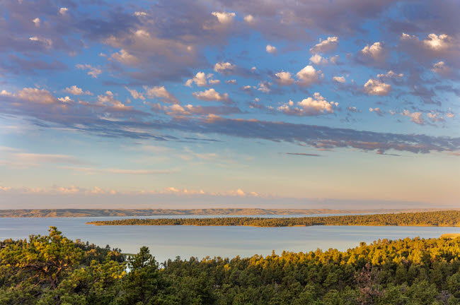 Fort Peck Reservoir poster print by Chuck Haney showcasing serene Montana landscape.