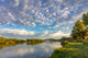Sunrise and Clouds Over Powder River Poster Print by Chuck Haney, showcasing the beautiful landscape of Montana.