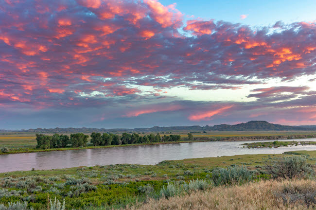 Sunrise and clouds over the Yellowstone River Poster Print by Chuck Haney