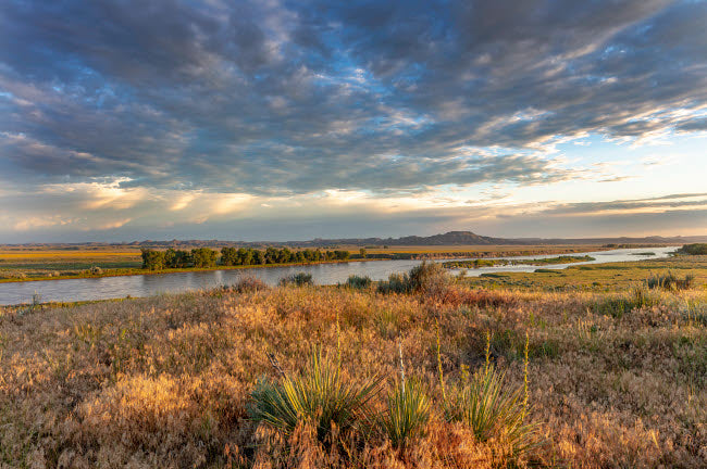 Sunrise and Clouds Over Yellowstone River Poster Print by Chuck Haney