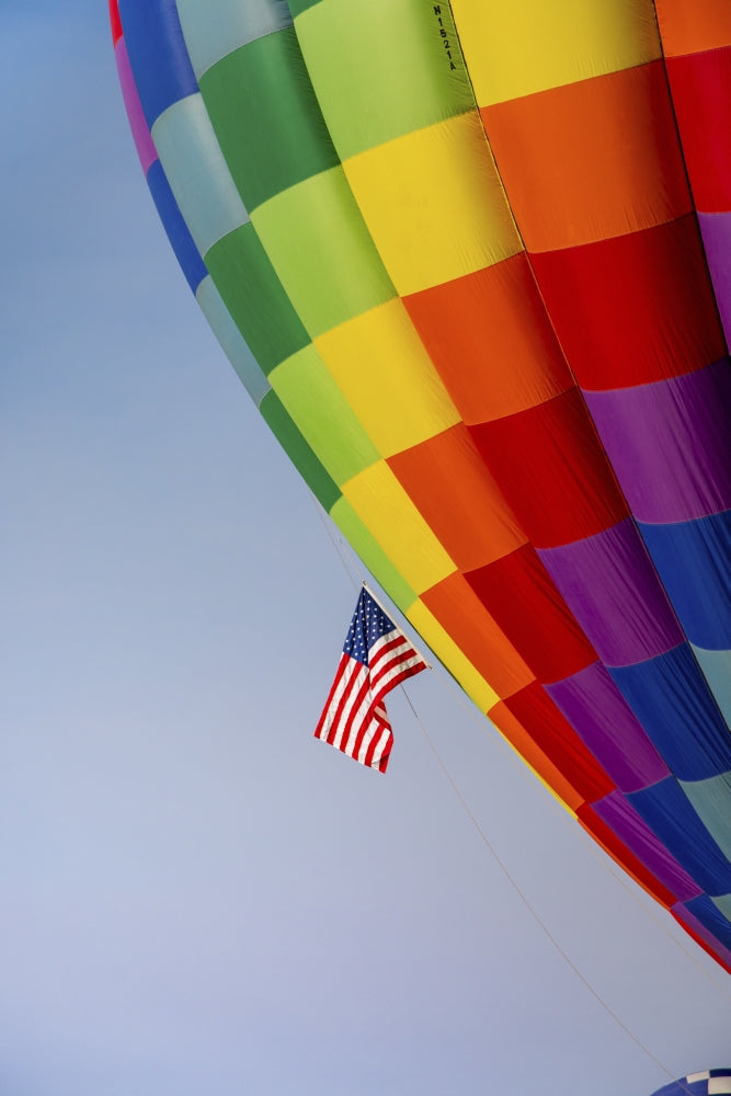 Colorful hot air balloon art print by Larry Ditto against a blue sky.