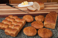 Multigrain bread rolls and loaf poster print with butter and knife.