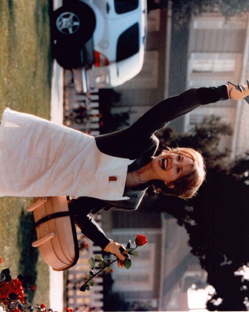 Annette Bening photo print cutting roses and waving.